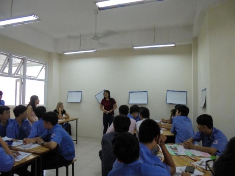 Một nhóm sinh viên đang thảo luận sôi nổi, tay cầm sách và ghi chép, thể hiện lợi ích của việc học tập và trao đổi về Tư tưởng Hồ Chí Minh.